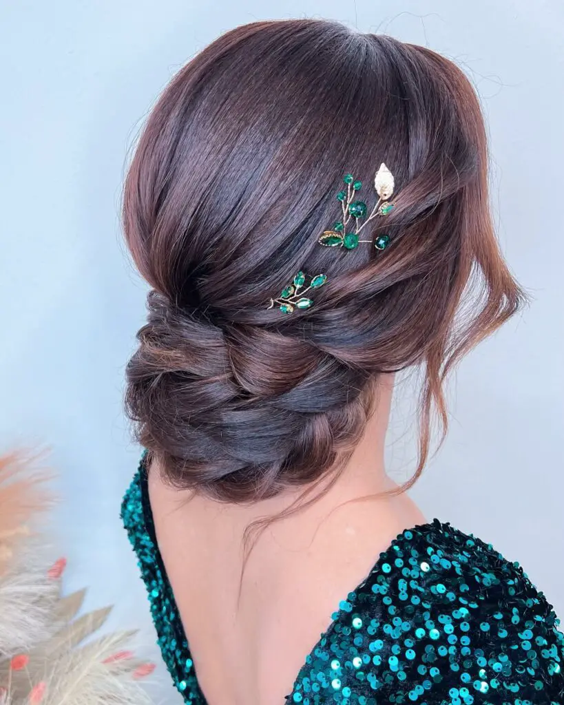 Refined low bun with an elegant side sweep for prom