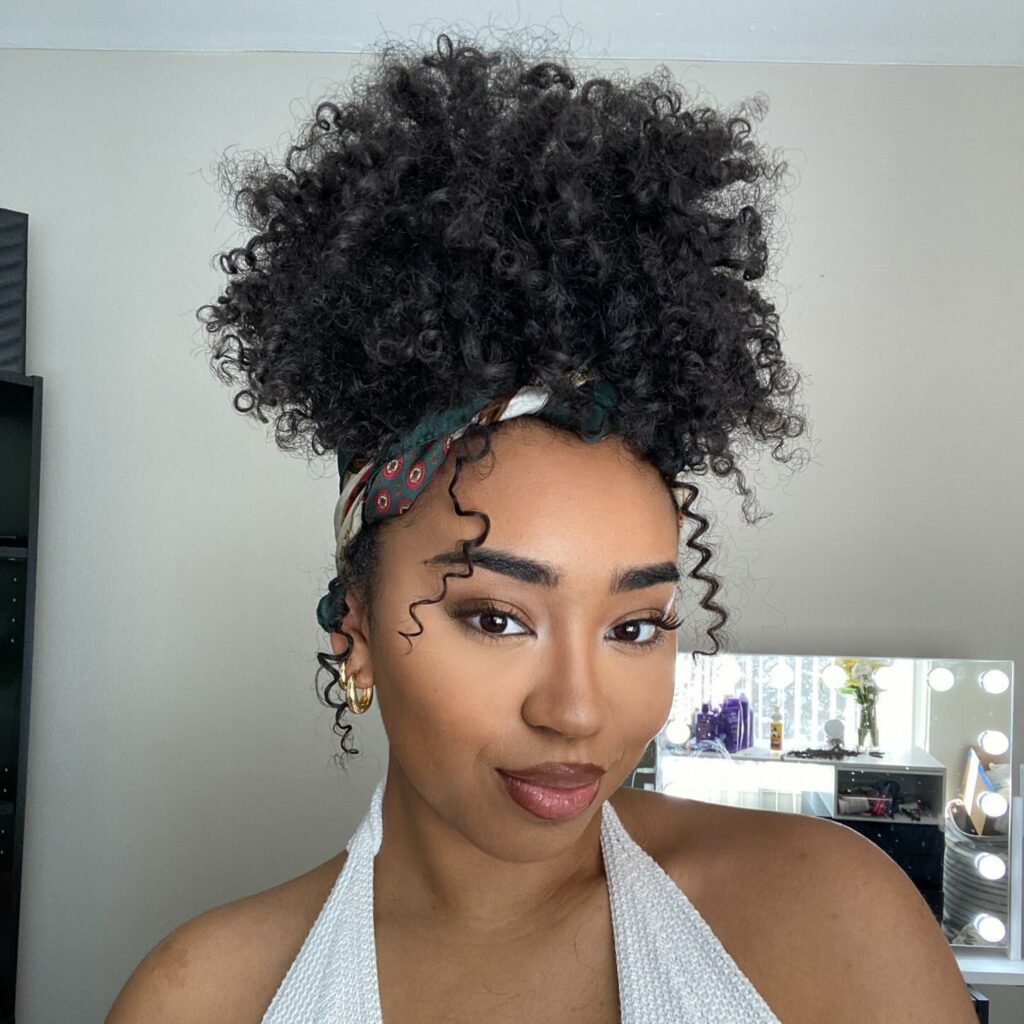 High-volume curly afro puff for summer look
