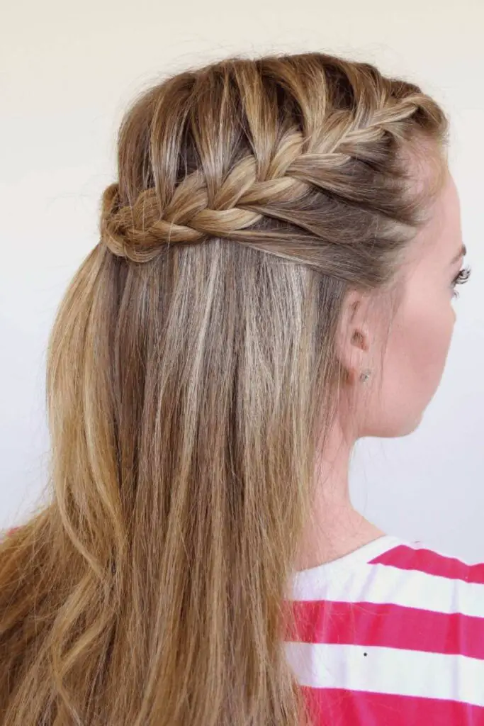 Classic and elegant French braid woven into a half-up hairstyle, creating a timeless and sophisticated look.