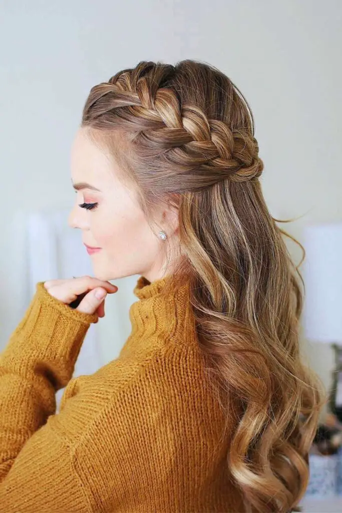 A dreamy French braid crown paired with a half-up half-down style, perfect for an ethereal and elegant vibe.