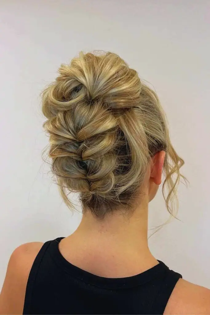 Eye-catching backwards bubble braid leading into a high bun, combining edgy and sophisticated styling for a trendy updo