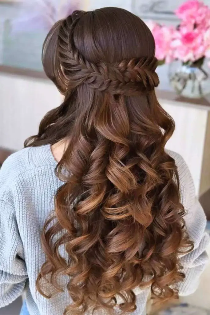 Regal half-up braided crown hairstyle with soft curls, a perfect choice for brides, proms, and formal events.