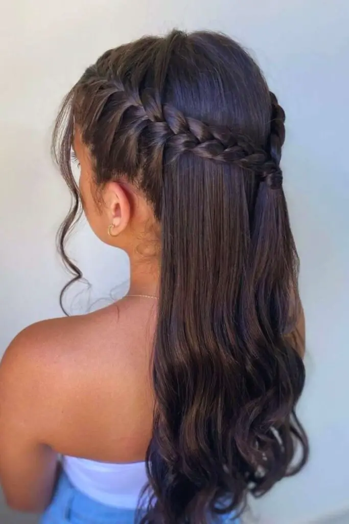 Simple yet stylish half-up hairstyle with a small braided section, perfect for casual days or quick styling.